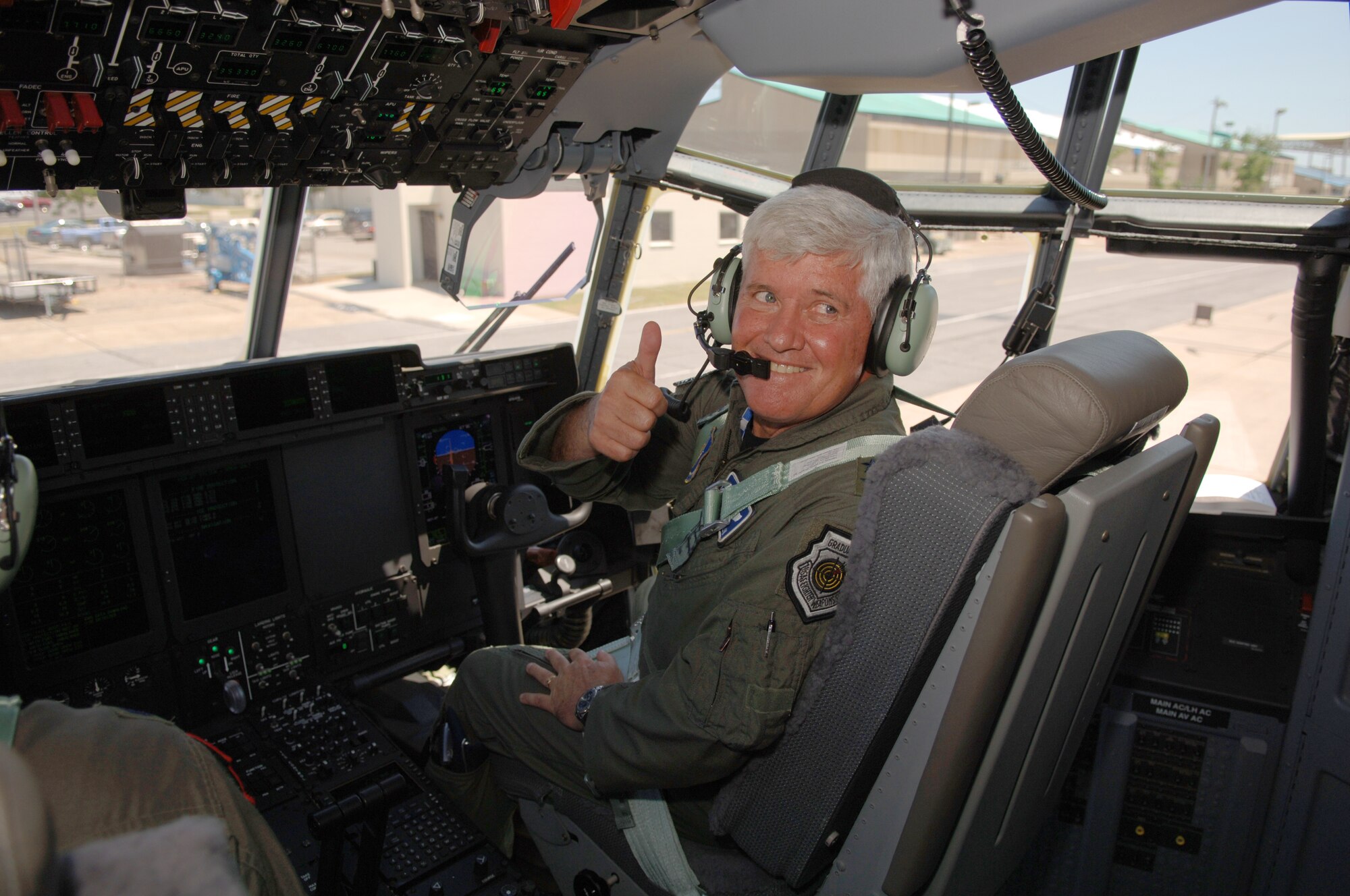 Maj. Gen. Allan R. Poulin, vice commander, Air Force Reserve Command, indicates a smooth ride and safe landing here May 26, when he delivered the latest addition to the 403rd Wing's fleet of C-130J-30 aircraft. A crew from the 403rd Wing accepted delivery of the new aircraft from Lockheed Martin, the manufacturer, in Marietta, Ga. earlier in the day. General Poulin, who spent much of his military career flying fighter aircraft, said he was impressed with the Herc. The 815th Airlift Squadron, the unit which employs the "stretched" transport, expects delivery of another aircraft before the end of the year. 