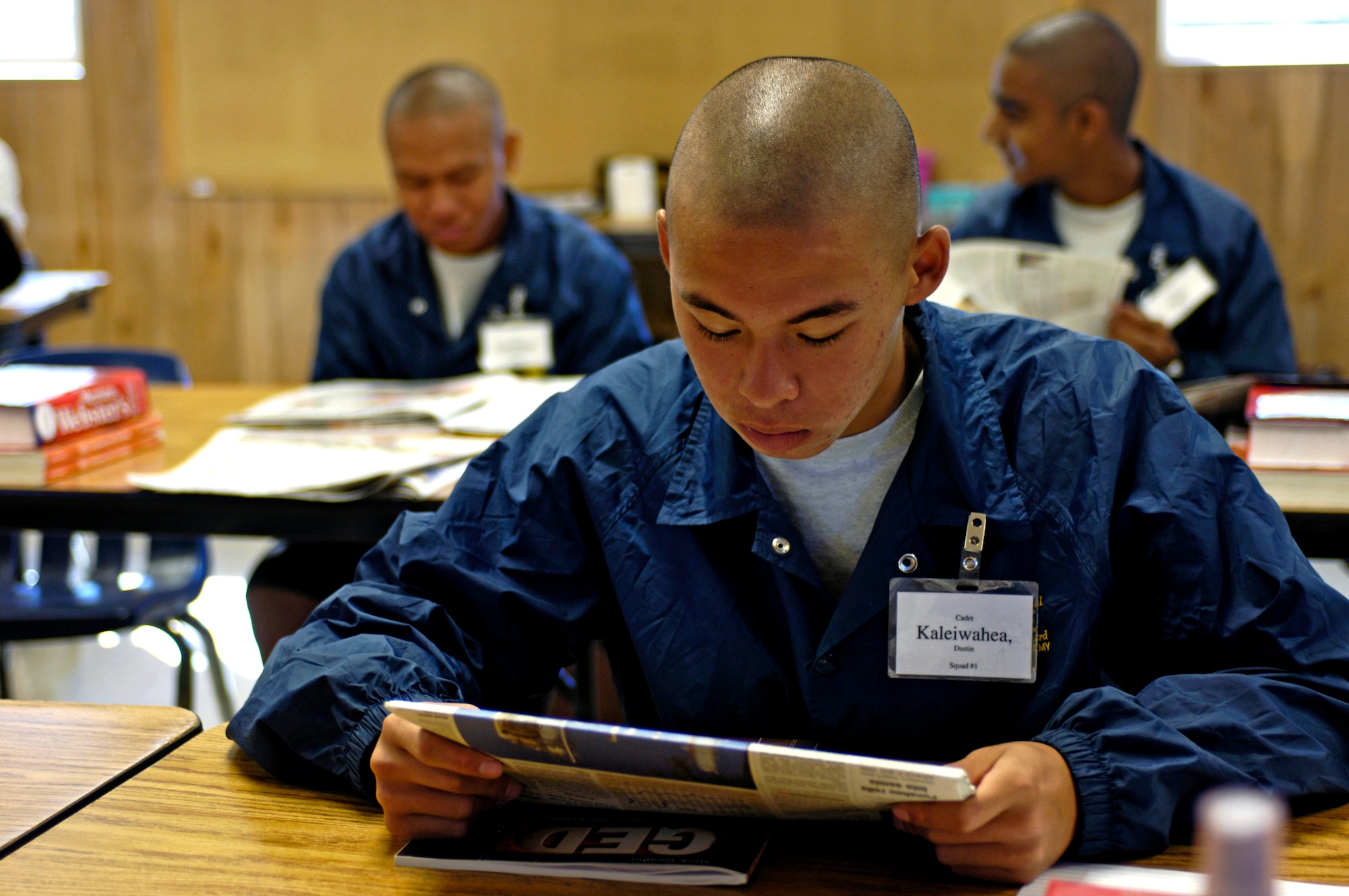 Cadet Dustin Kaleiwahea reads about current events at the Hawaii National Guard Youth Challenge Academy in Kapolei, Hawaii on Thursday, May 18, 2006. The academy staff teach life skills to non-traditional students so they can be successful in the community and earn a high school diploma.  (U.S. Air Force photo/Tech. Sgt. Shane A. Cuomo)