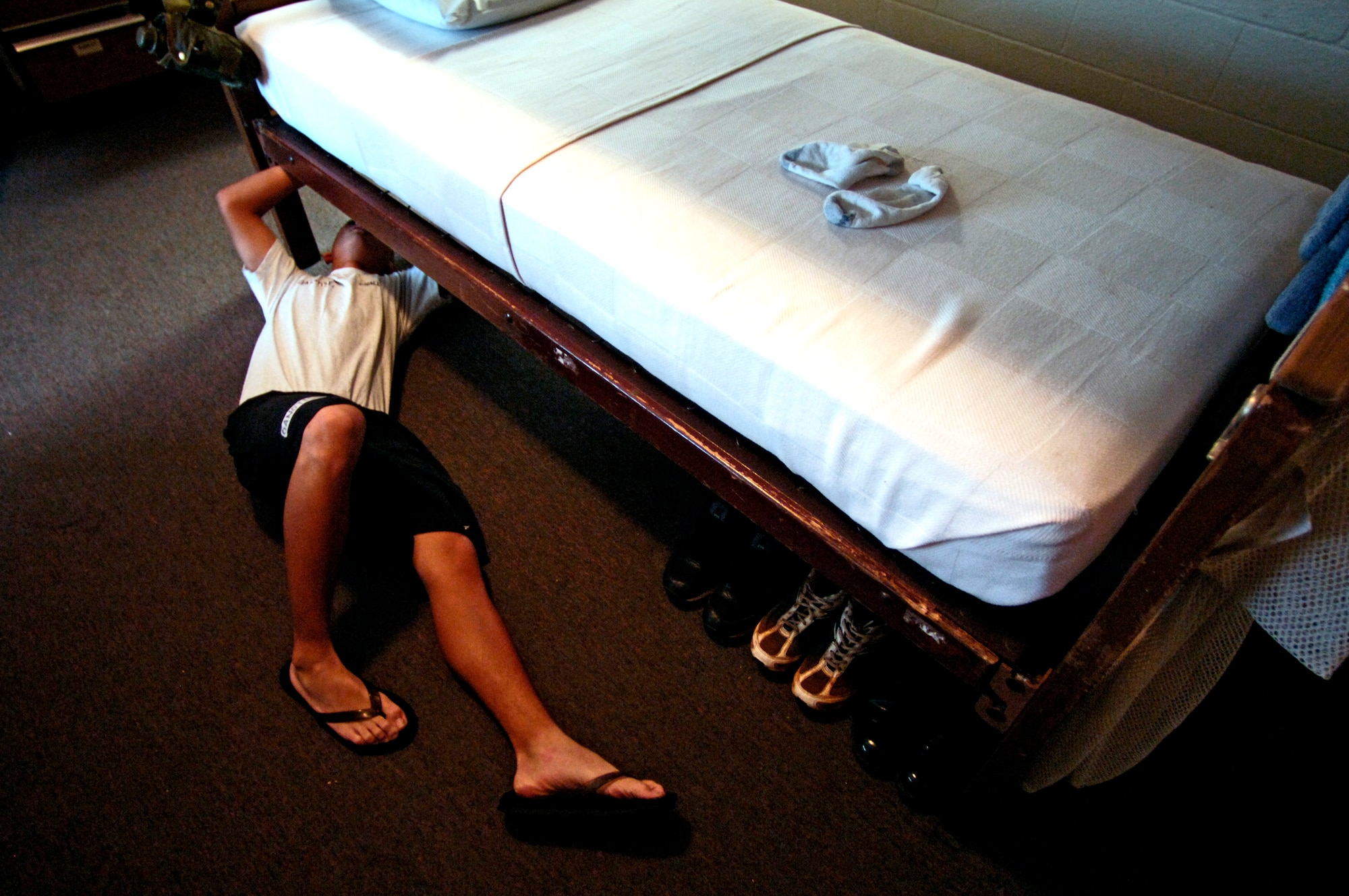 A cadet pulls his sheets tight to get his bed ready for inspection on Thursday, May 18, 2006 at the Hawaii National Guard Youth Challenge Academy in Kapolei, Hawaii. The academy staff teach life skills to non-traditional students so they can be successful in the community and earn a high school diploma.  (U.S. Air Force photo/Tech. Sgt. Shane A. Cuomo)