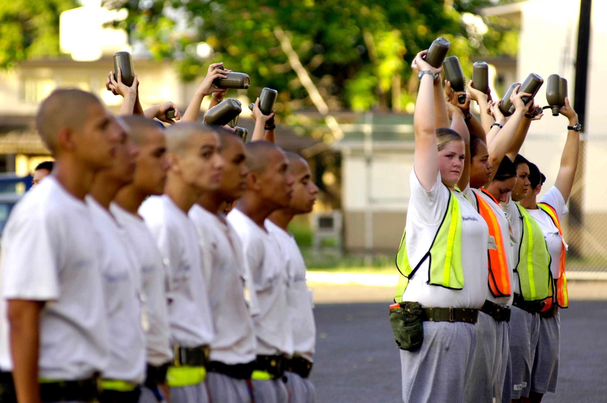 Cadets hold their canteens over their heads to show they finished all their water at the Hawaii National Guard Youth Challenge Academy in Kapolei, Hawaii, on Thursday, May 18, 2006. The academy staff teach life skills to non-traditional students so they can be successful in the community and earn a high school diploma.  (U.S. Air Force photo/Tech. Sgt. Shane A. Cuomo)