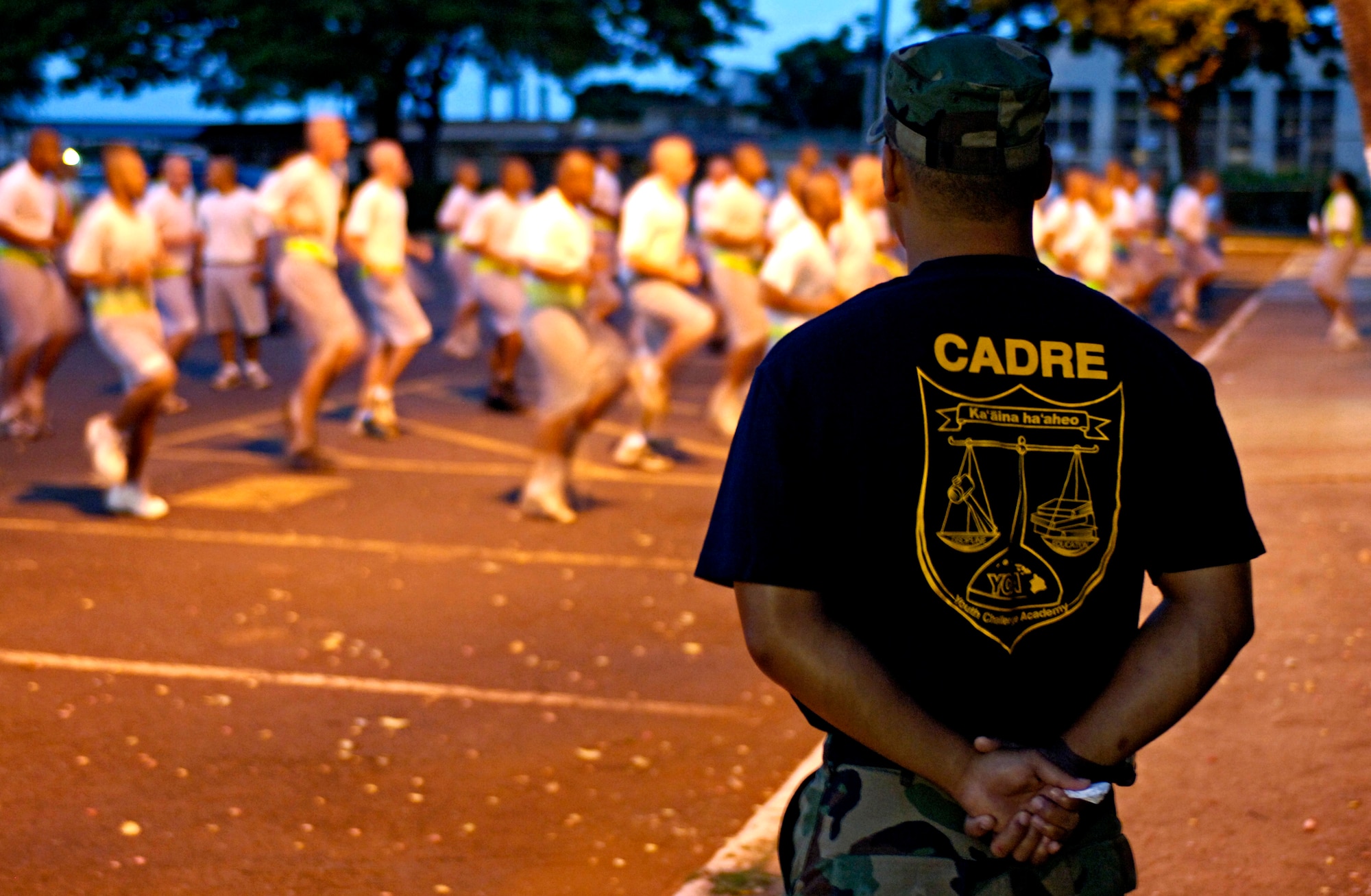 Staff Sgt. Alika Kaahanui watches over cadets as they perform their morning physical exercise on Thursday, May 18, 2006 at the Hawaii National Guard Youth Challenge Academy in Kapolei, Hawaii. The academy staff teach life skills to non-traditional students so they can be successful in the community and earn a high school diploma.  (U.S. Air Force photo/Tech. Sgt. Shane A. Cuomo)