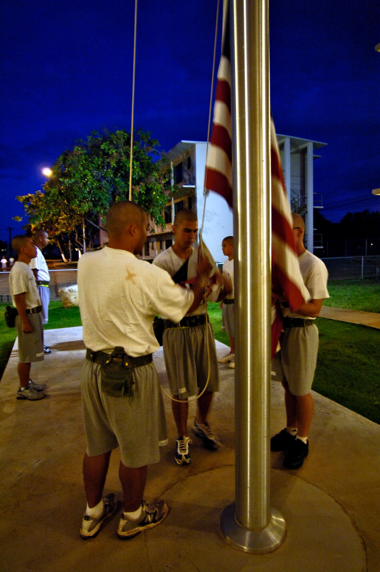 Cadets raise the flag at the Hawaii National Guard Youth Challenge Academy in Kapolei, Hawaii, on Thursday, May 18, 2006. The academy staff teach life skills to non-traditional students so they can be successful in the community and earn a high school diploma.  (U.S. Air Force photo/Tech. Sgt. Shane A. Cuomo)