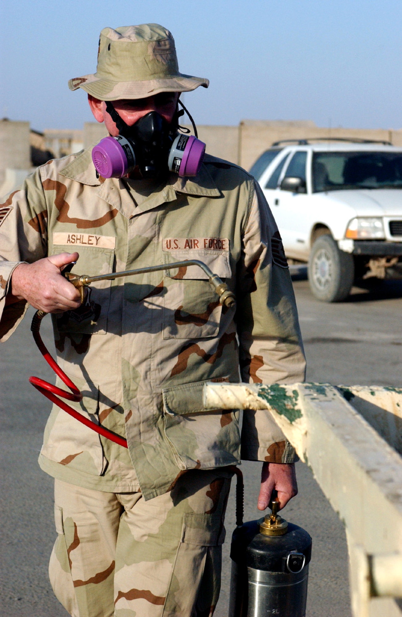 Tech. Sgt. David Ashley sprays insecticide around a dumpster to keep flies down.  He is assigned to the 407th Expeditionary Civil Engineer Squadron entomology flight at Ali Base, Iraq.  (U.S. Air Force photo/Master Sgt. Andrew Gates)