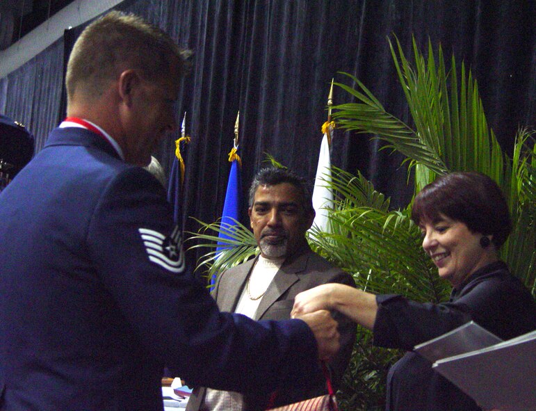 Tech Sgt Jeffrey Vaughan, Det 1, 125th Fighter Wing Air Defense Warrior of the Year, receives an award from Suzette Rice of the Office of Miami-Dade Mayor Carlos Alvarez. (Air Force photo by Lisa Macias)    