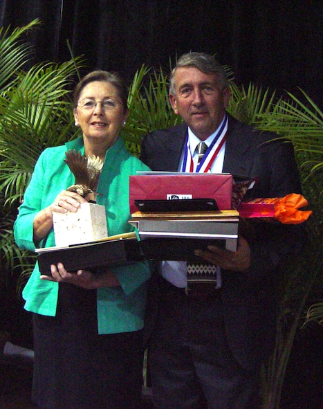Larry Carrier, 482nd Fighter Wing Civilian of the Year, needs help from his supervisor Christiane Sable just to carry all of the awards he received during the ceremony.  (Air Force photo by Lisa Macias) 