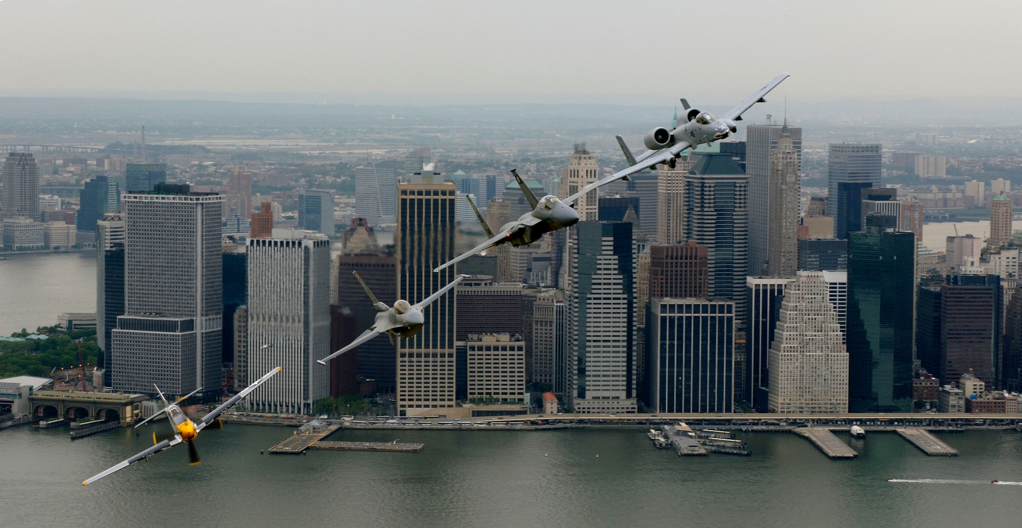 A P-51 Mustang, flown by Jim Beasley; an F-16 Fighting Falcon, flown by Maj. Dax Cornelius from Hill Air Force Base, Utah; an F-15 Eagle, flown by Capt. Tony Bierenkoven from Eglin AFB, Fla.; and an A-10 Thunderbolt II, flown by Capt. Jeff Yost of Pope AFB, N.C., fly over New York City on Thursday, May 25, 2006. The "Heritage Flight" pilots flew in the Jones Beach Air Show on Long Island. Heritage Flight formations are designed to show generations of fighter aircraft. (U.S. Air Force photo/Tech. Sgt. Ben Bloker) 