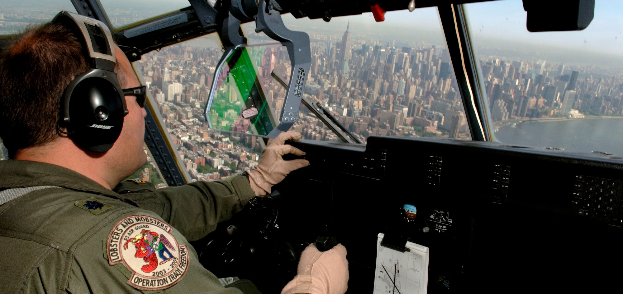 Lt. Col. Todd Oliver scans the New York City skyline during a media flight over the famous city on Thursday, May 25, 2006.  Colonel Oliver was piloting a C-130 Hercules, the support aircraft for "Heritage Flight" pilots flying in the Jones Beach Air Show on Long Island. Heritage Flight formations are designed to show generations of fighter aircraft history. The colonel is from the Rhode Island Air National Guard. (U.S. Air Force photo/Tech. Sgt. Ben Bloker) 