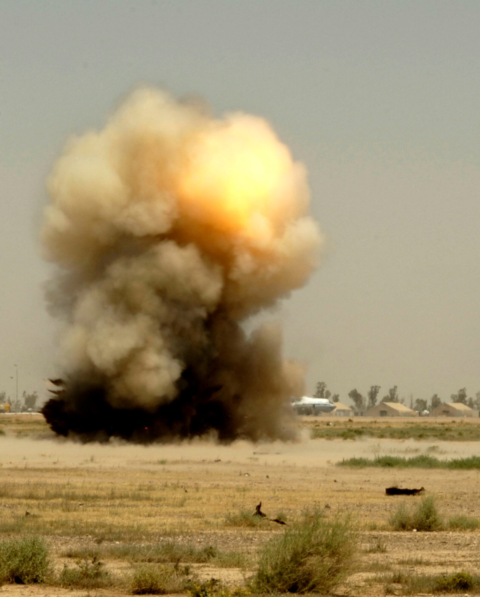 A controlled detonation explodes at Balad Air Base, Iraq, on Monday, May 22, 2006. Explosive ordnance disposal technicians from the 332nd Expeditionary Civil Engineer Squadron use the range when they find unexploded ordnance on base. (U.S. Air Force photo/Airman 1st Class Andrew Oquendo) 
