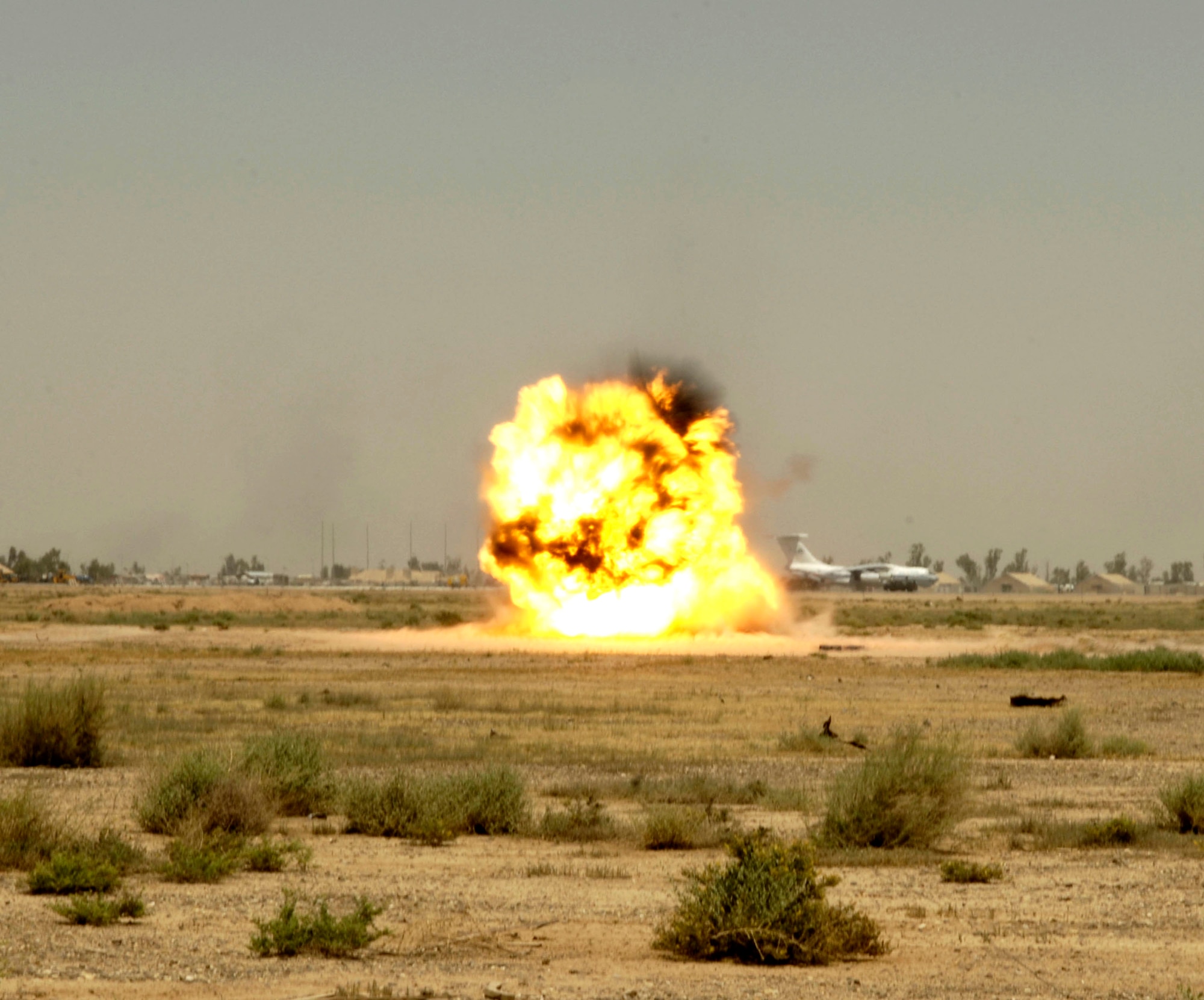 A controlled detonation explodes at Balad Air Base, Iraq, on Monday, May 22, 2006. Explosive ordnance disposal technicians from the 332nd Expeditionary Civil Engineer Squadron use the range when they find unexploded ordnance on base. (U.S. Air Force photo/Airman 1st Class Andrew Oquendo)
