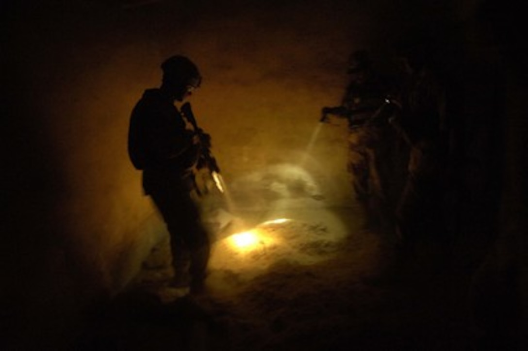 U.S. Army 2nd Lt. Matthew Biellik searches an abandoned house for hidden weapons during a joint operation with the Iraqi army in Tall Afar, Iraq, on May 23, 2006. Beillik is from the 1st Brigade Combat Team, 1st Armored Division. 