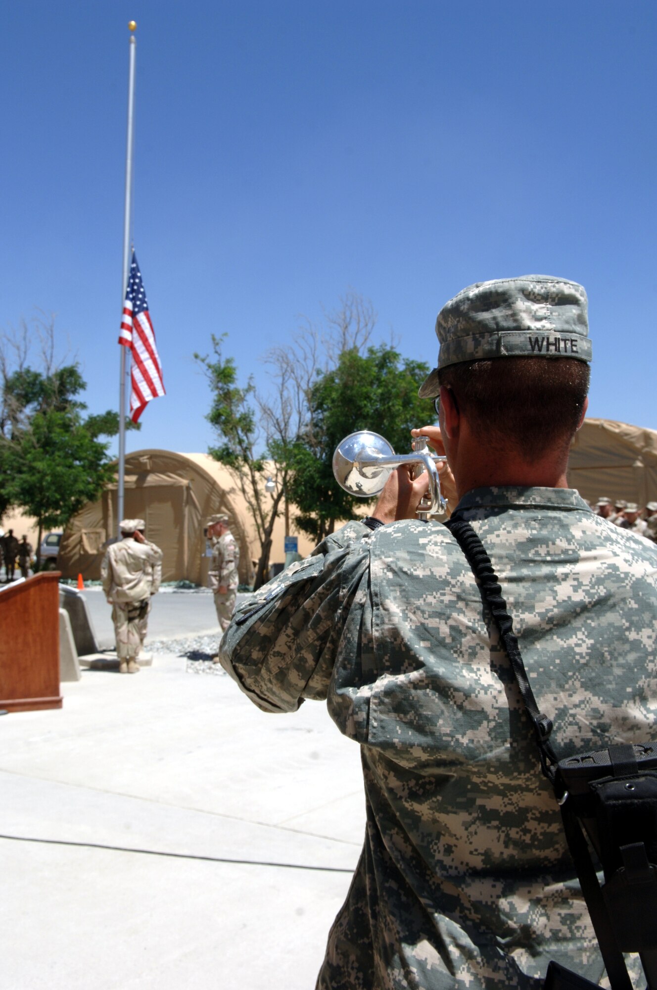 BAGRAM AIRFIELD, Afghanistan -- An Army bugler plays Taps during the closing moments of a memorial
ceremony held here May 13 by the 455th Expeditionary Security Forces Squadron in remembrance of 18 Airmen who were killed trying to end the USS Mayaguez incident in 1975.  (Photo by Master Sgt. Orville Desjarlais Jr.)