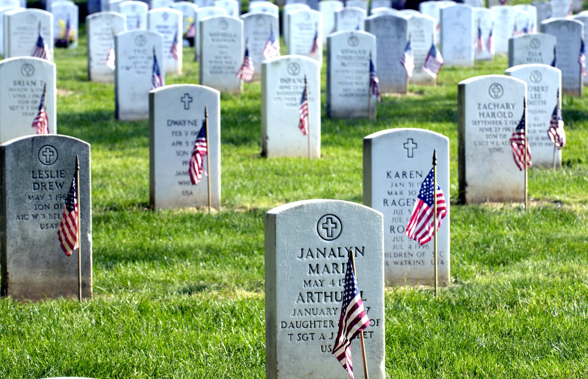 Soldiers, Sailors, Airmen and Marines from across the Washington D.C. area joined forces to place more than 227,000 flags at the front of headstones at Arlington National Cemetery on Thursday, May 25, 2006. The flags will remain at the headstones through Memorial Day. (U.S. Air Force photo/Master Sgt. Jim Varhegyi)