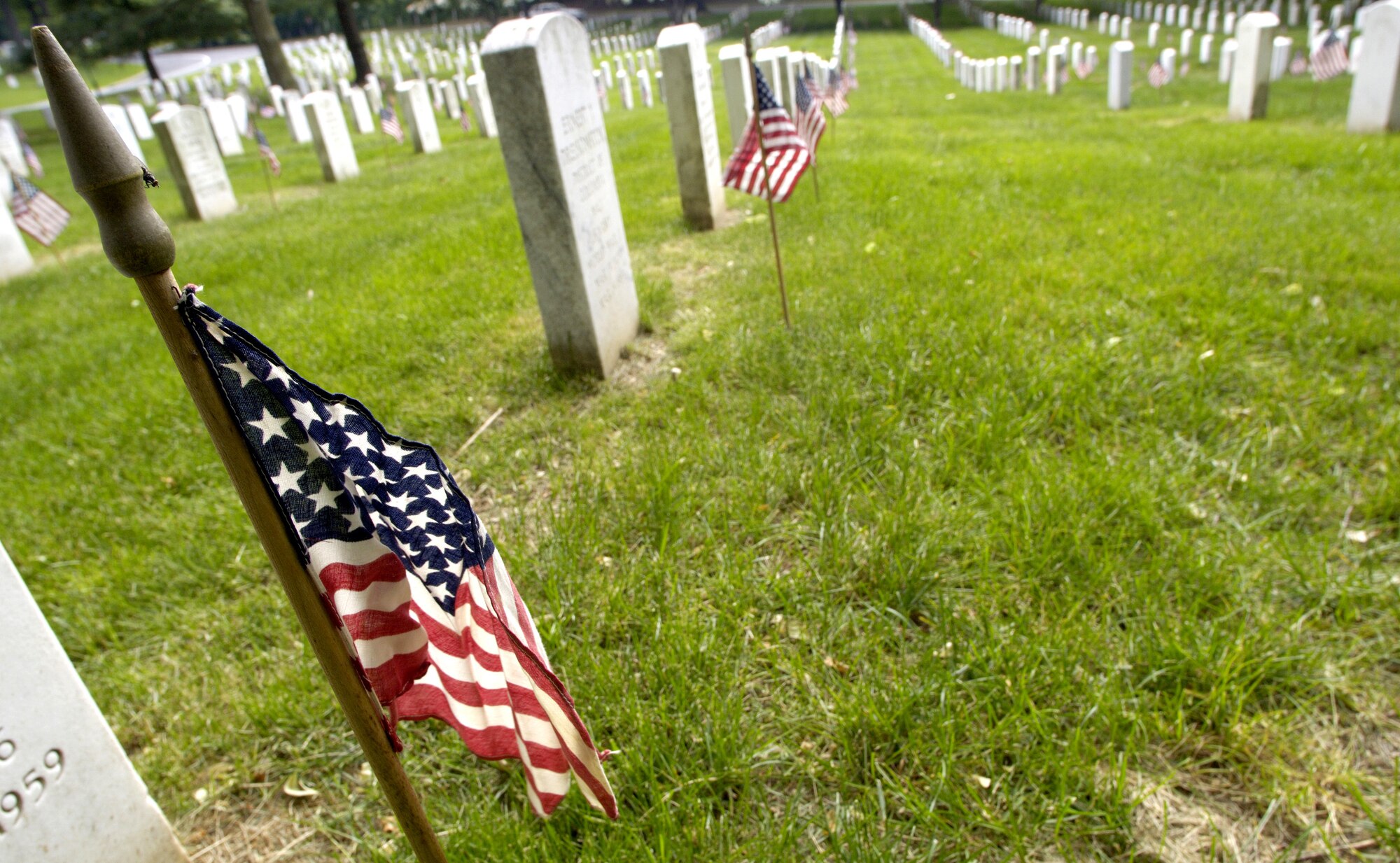 Soldiers, Sailors, Airmen and Marines from across the Washington D.C. area joined forces to place more than 227,000 flags at the front of headstones at Arlington National Cemetery on Thursday, May 25, 2006. The flags will remain at the headstones through Memorial Day. (U.S. Air Force photo/Master Sgt. Jim Varhegyi)