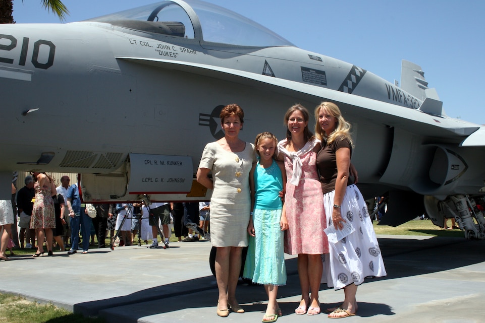 The family of Lt. Col. John C. Spahr stand in front of an F/A-18 Hornet May 29, during a Memorial Day service at the Palm Springs Air Museum, Palm Springs Calif. The Museum repainted the plane to mimic the Marine Fighter Attack Squadron 323 paint scheme in memory of Lt. Col. Spahr and Capt. Kelly C. Hinz, who died in a plane crash May 2, 2005.