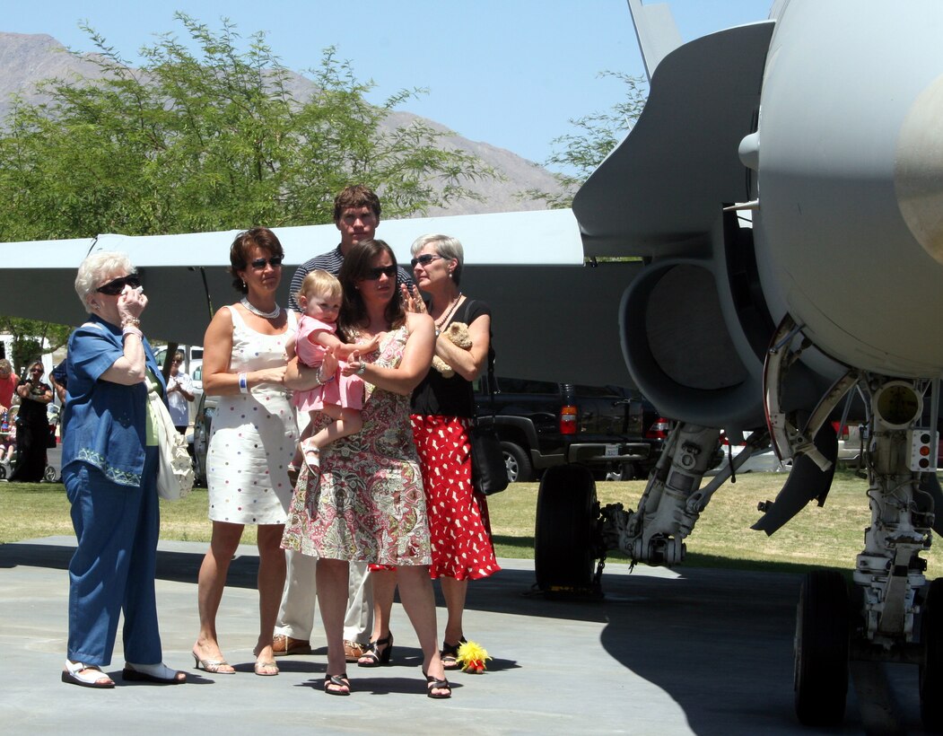 The family of Capt. Kelly C. Hinz gathers next to a F/A-18 Hornet dedicated to him in his honor at the Palm Springs Air Museum, Palm Springs Calif. The Museum repainted the plane in the Marine Fighter Attack Squadron 323 paint scheme in memory of Lt. Col. Spahr and Capt. Kelly C. Hinz.