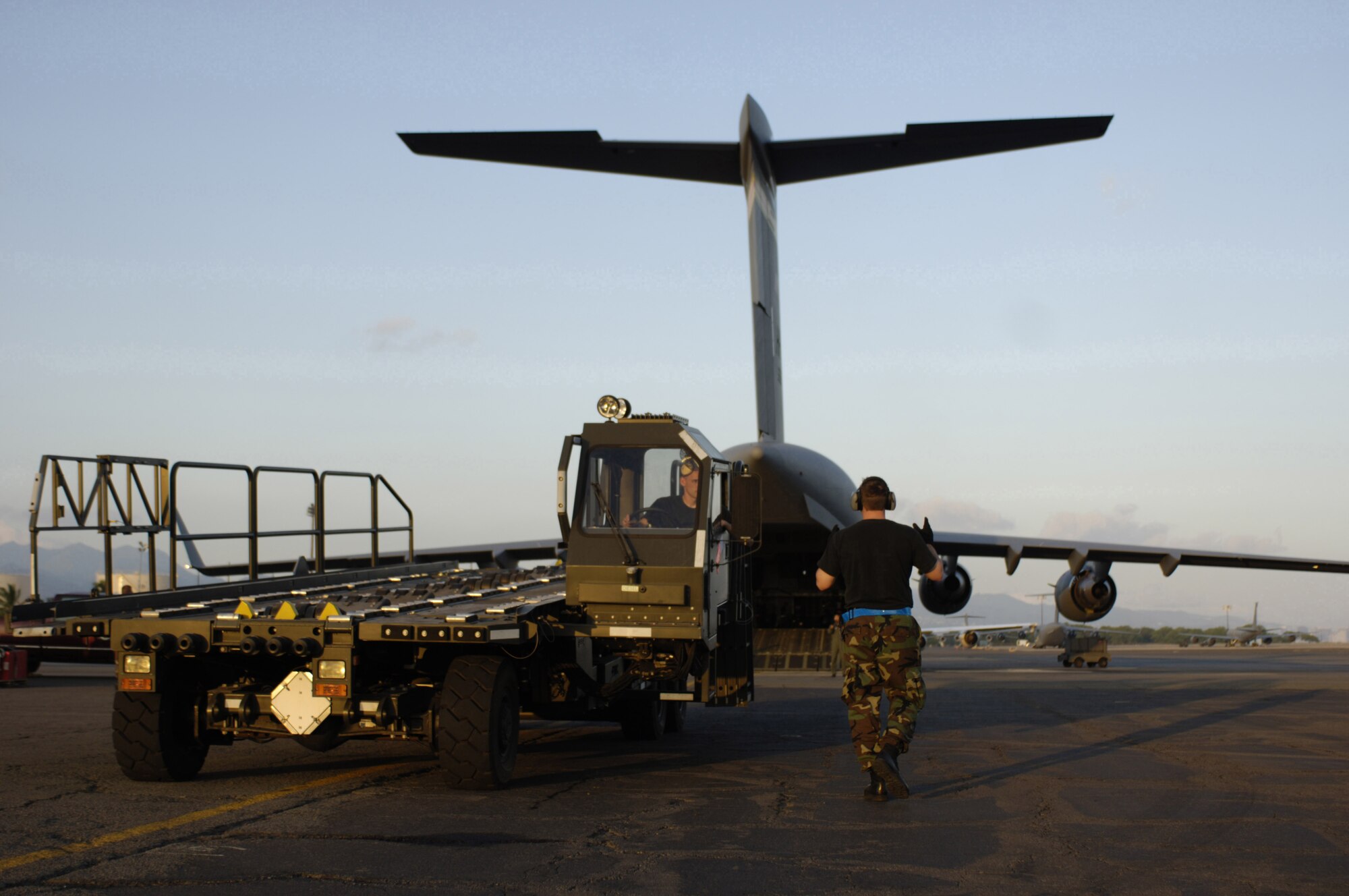 HICKAM AIR FORCE BASE, HAWAII -- Staff Sgt. Nathan Rust, an aerial port specialist assigned to the 735th Air Mobility Squadron, Hickam Air Force Base, Hawaii, backs a Halvorsen aircraft pallet loader onto a C-17 May 25.   Hickam Air Force Base sent the loaders along with two C-17s and approximately 25 personnel to assist the Australian Defense Force move personnel and equipment to Australia from the Solomon Islands in support of peace operations in East Timor after continued unrest between East Timorese military forces and breakaway groups of police and military. (U.S. Air Force Photo by Tech. Sgt. Shane Cuomo)  