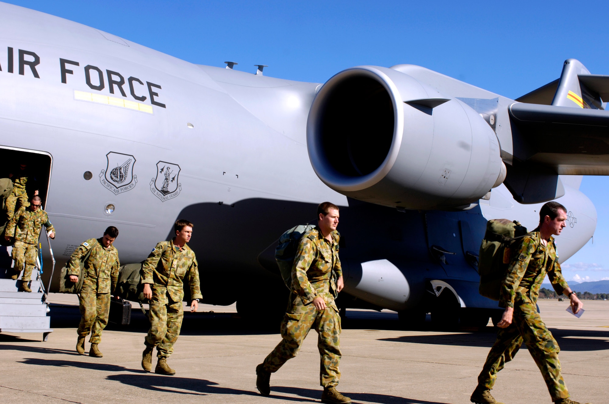 Members of the Australian Defense Force disembark from a C-17 Globemaster III at Royal Air Force Base Richmond, Australia, on Sunday, May 28, 2006. Two C-17 Globemaster IIIs and their crews are helping the Australian Defense Force reposition its forces from the Solomon Islands back to Australia to better support peace operations in East Timor. (U.S. Air Force photo/Tech. Sgt. Shane A. Cuomo) 