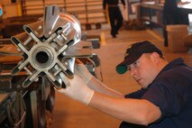 Navy Seaman Gregory Petit, Mobile Mine Assembly Unit 11, Charleston, S.C., sets up a fin on a MK-62 Quickstrike training mine at a munitions building here during Trident Fury. The U.S. Navy joined Team Minot for Trident Fury, a multi-national training event combining land, sea, and air components. (U.S. Air Force photo by Senior Airman Danny Monahan)