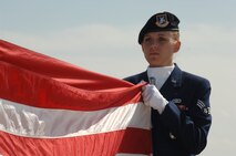 Senior Airman Elizabeth Corp, 5th Security Forces Squadron, folds the flag after taking it down during the annual Police Memorial Week retreat ceremony at the base flag pole here May 19th.  (U.S. Air Force photo by Airman 1st Class Christopher Boitz)