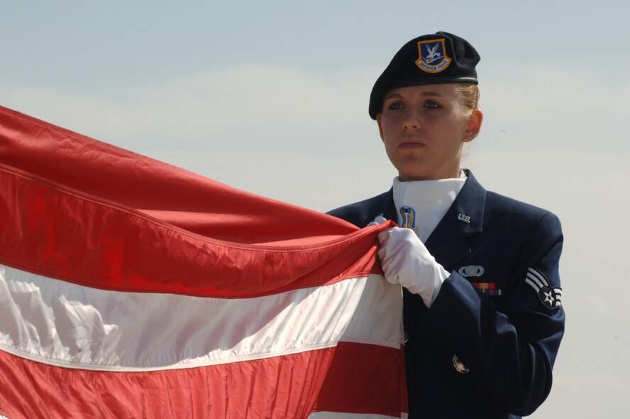 Senior Airman Elizabeth Corp, 5th Security Forces Squadron, folds the flag after taking it down during the annual Police Memorial Week retreat ceremony at the base flag pole here May 19th.  (U.S. Air Force photo by Airman 1st Class Christopher Boitz)