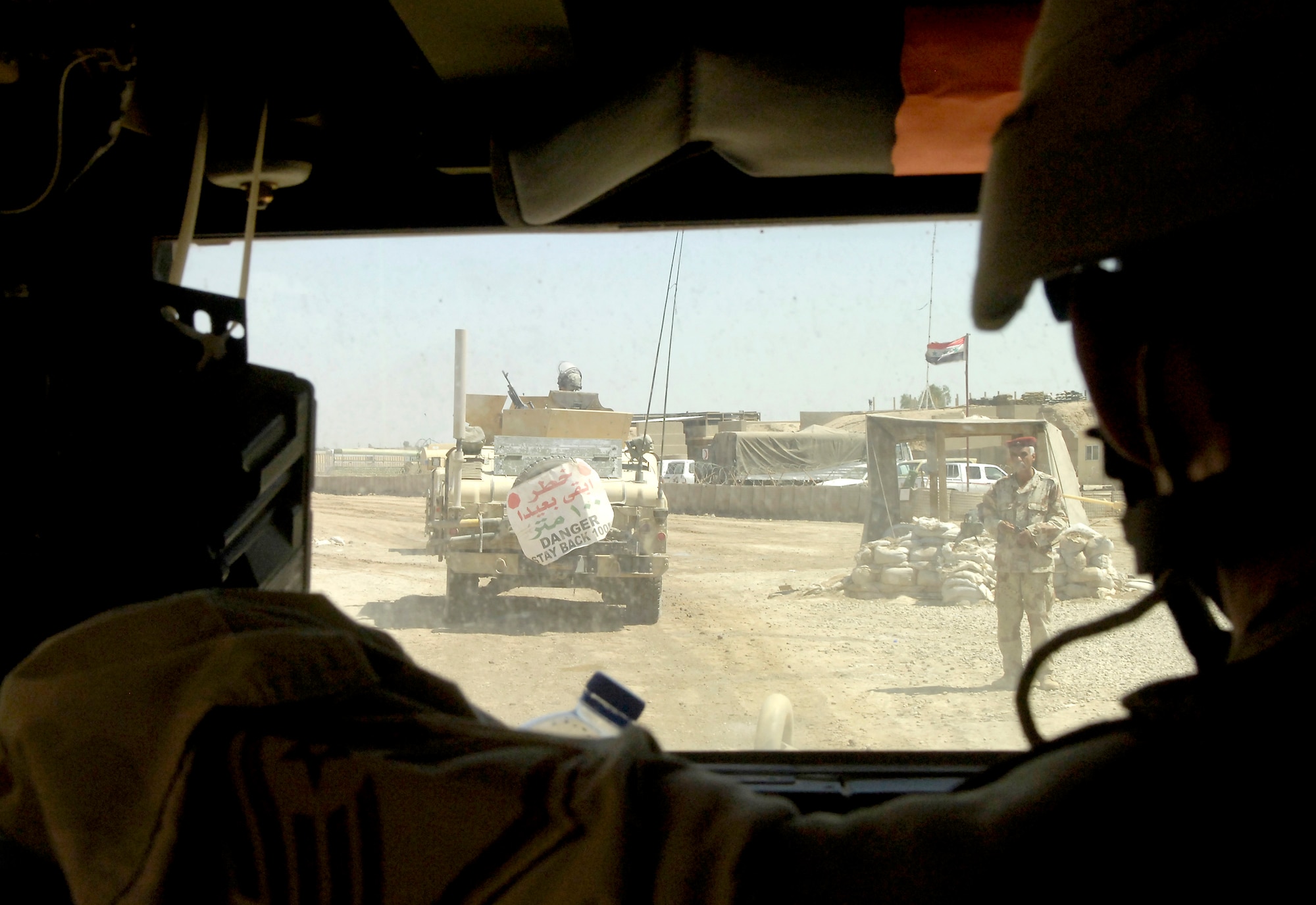 Master Sgt. Tony Pesson observes the operations of the 1st Iraqi Army Division/Iraqi Intervention Forces, as his convoy enters the base on Thursday, May 25, 2006.  Sergeant Pesson is the NCO in charge of Air Force Base Defense Unit Team 3602, which advises and trains the Iraqi Army on base defense procedures. (U.S. Air Force photo/Senior Airman Brian Ferguson)

