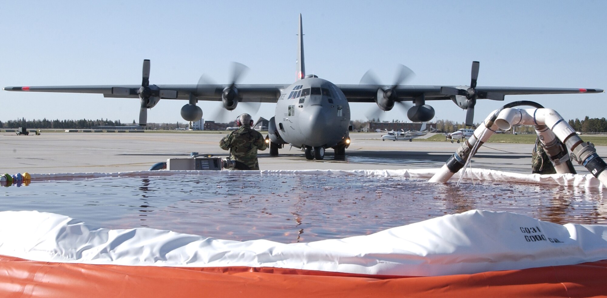 Members of the 302nd Airlift Wing test the Modular Airborne Fire Fighting System at Peterson Air Force Base, Colo., in preparation for the 2006 wild fire season. (U.S. Air Force photo/Tech Sgt. Timothy Taylor)