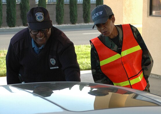 Chief Master Sgt. Carol Johnson, 60th Air Mobility Wing interim command chief, greets members at the main gate and reminds them to have a safe Memorial Day weekend. (U.S. Air Force photo by Staff Sgt. Raymond Hoy)
