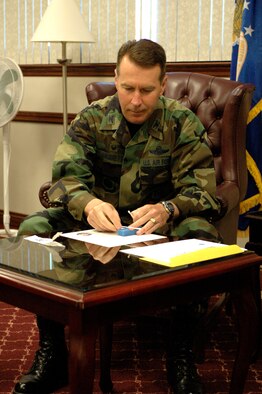 Col. Steven Arquiette, 60th Air Mobility Wing commander, places a swab in an envelope to be placed on the national bone marrow donation registry. (U.S. Air Force photo by Staff Sgt. Raymond Hoy)