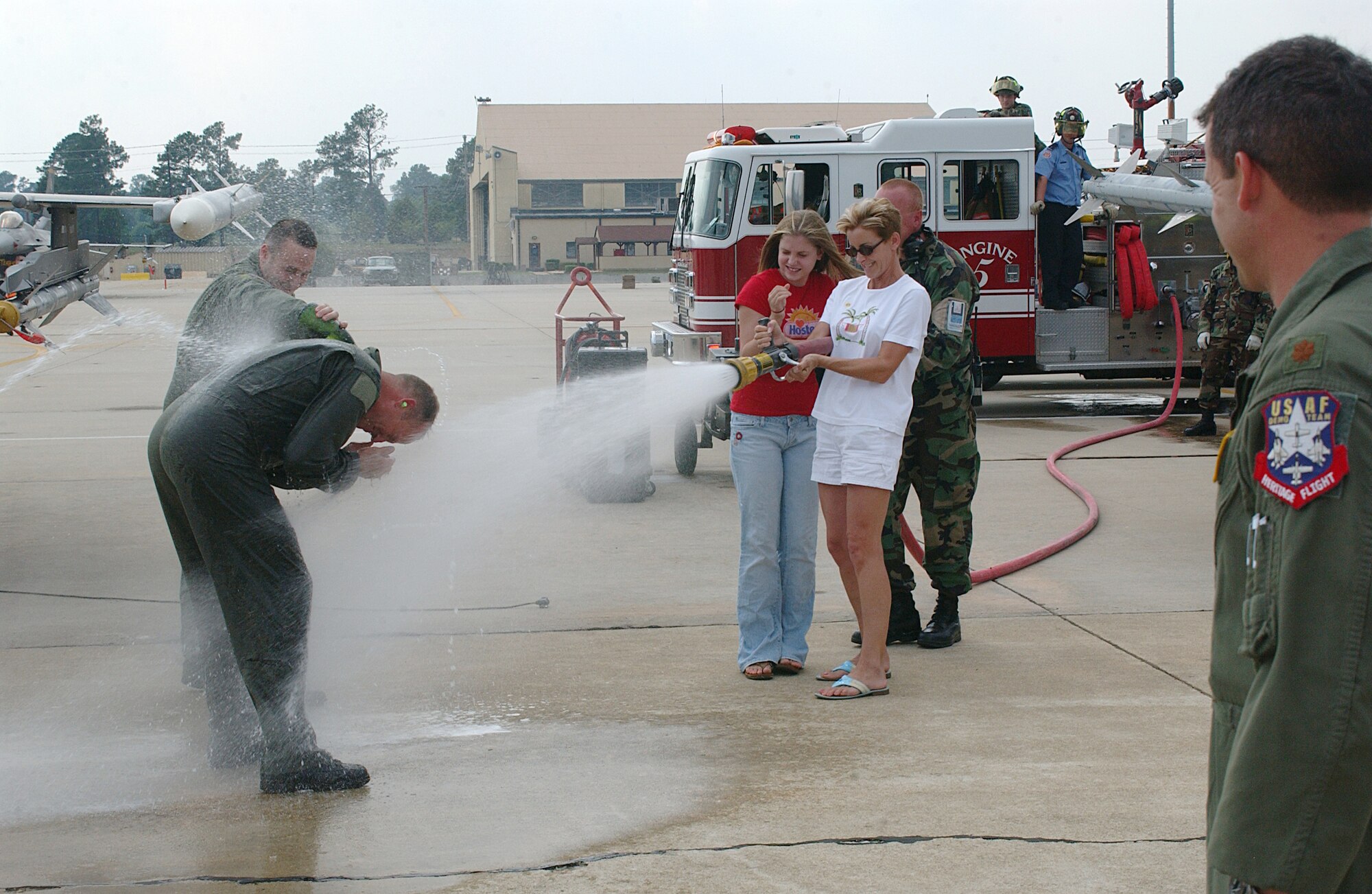 Upon landing from his last flight as 20th Fighter Wing vice commander, Col. Michael Beale is greeted by colleagues and a blast of water from his wife, Karen, and daughter, Bronte.  Col. Beale and his family are moving to Tyndall Air Force Base, Fla.  (U.S. AIr Force Photo/Staff Sgt. Nathan Brevier)