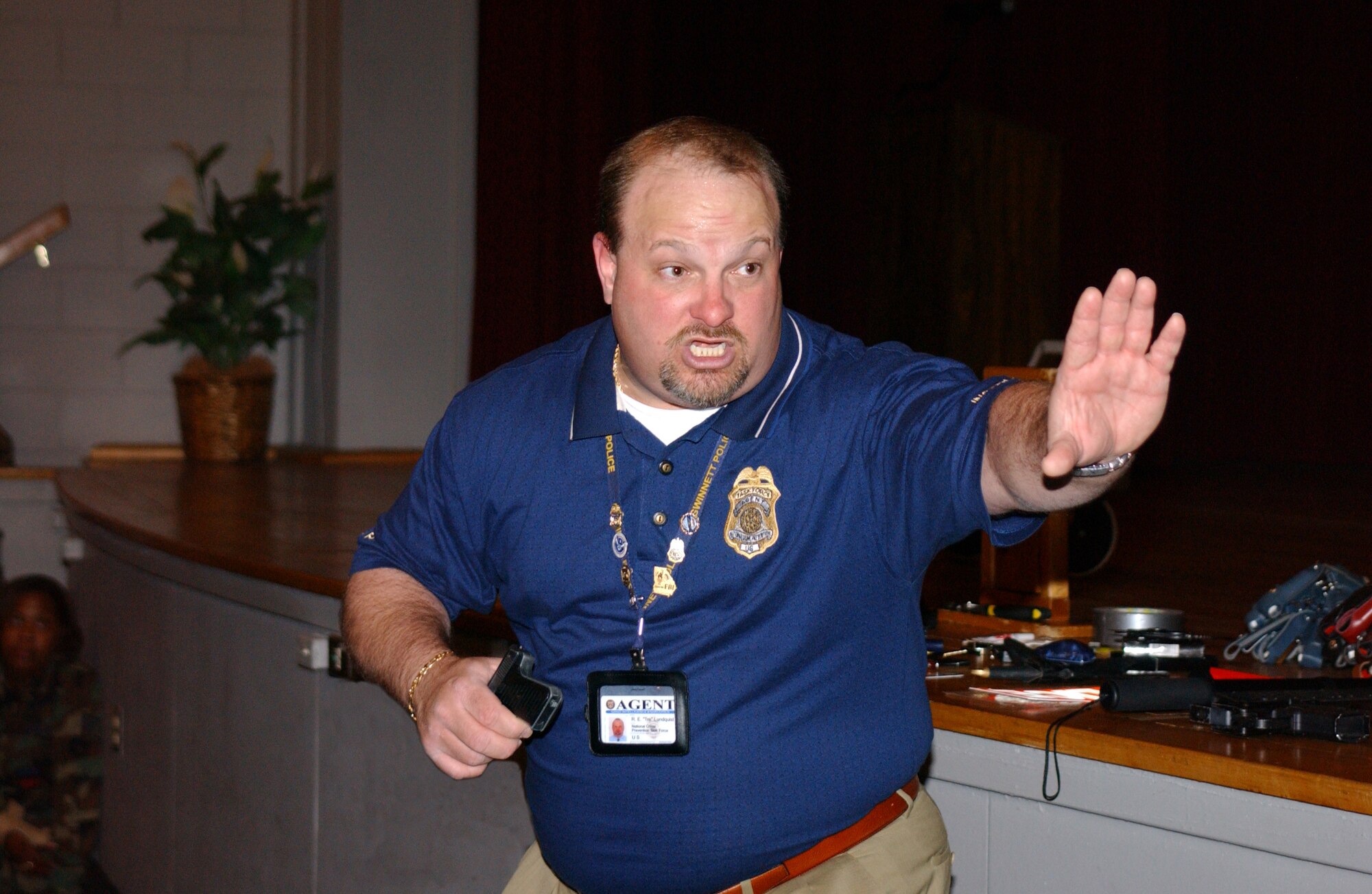 Officer Tre Lundquist, Public Safety Coalition, demonstrates self-defense techniques May 19 at the base theater.  Officer Lundquist was featured in three separate safety briefings in conjunction with Safety Day.  (U.S. Air Force Photo/Airman 1st Class Katherine Dodd)