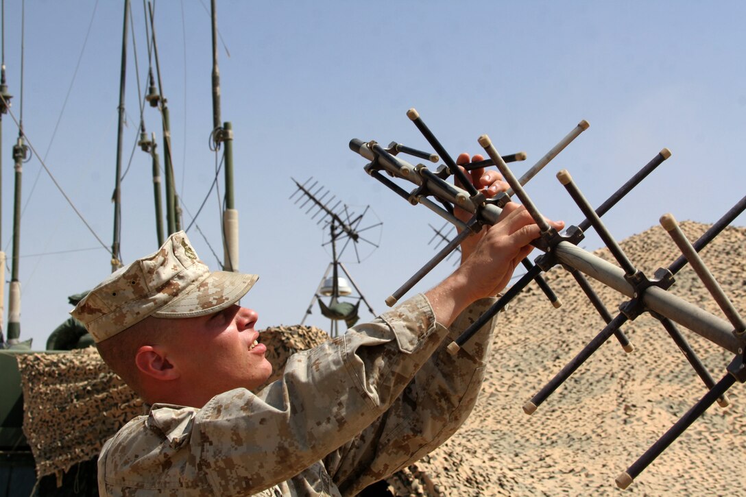 Lance Cpl. Alvin B. Messina extends the leaves of a satellite communication antenna at Al Asad, Iraq, May 30. Messina is an aviation radio technician with Marine Tactical Air Command Squadron 38, Marine Air Control Group 38 (Reinforced), 3rd Marine Aircraft Wing. He is a 25-year-old native of Texas City, Texas.