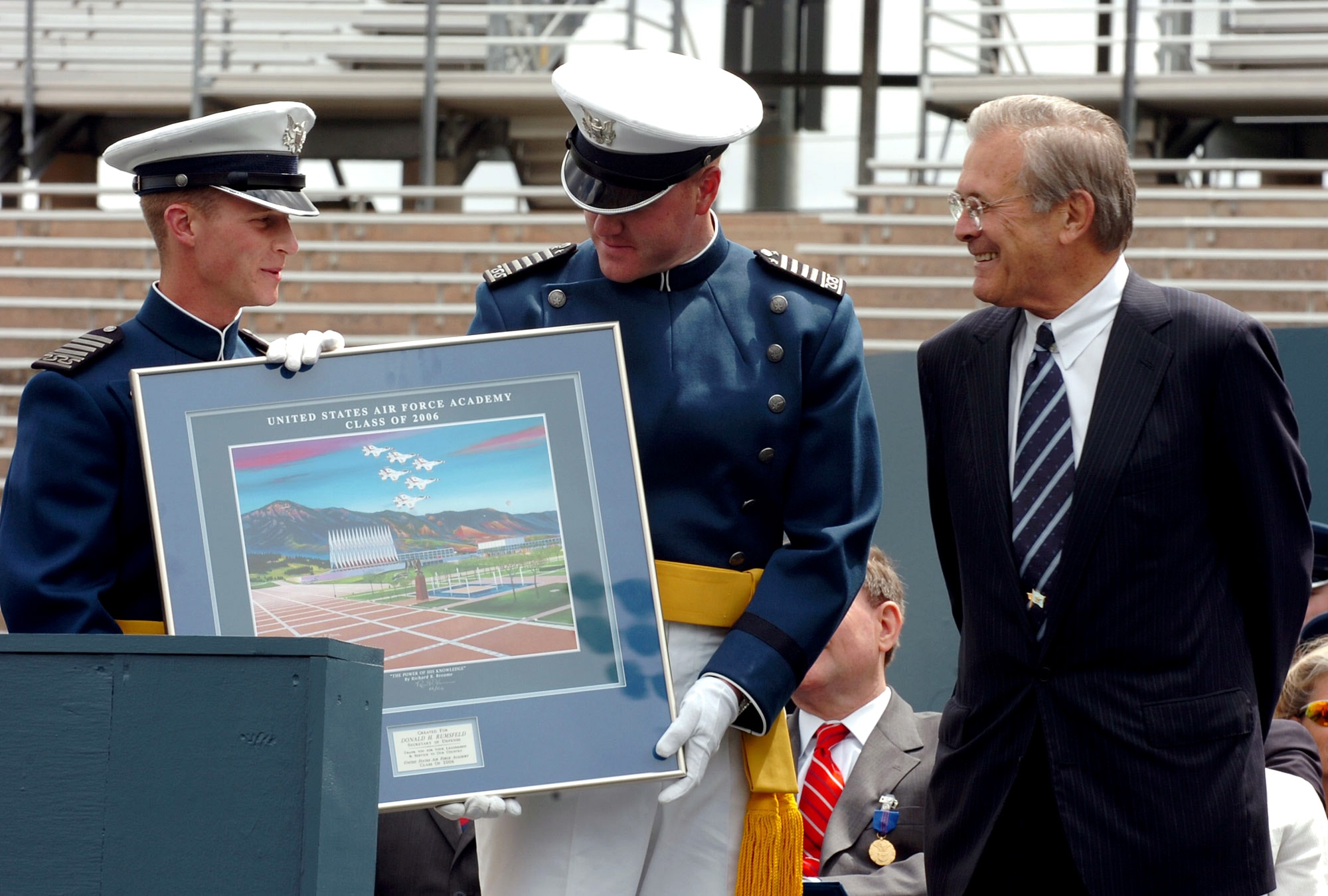 Secretary of Defense Donald H. Rumsfeld is presented a gift after delivering the commencement address to the 2006 graduating class of the U.S. Air Force Academy in Colorado Springs, Colo., on Wednesday, May 31, 2006. (Defense Department photo/Petty Officer 1st Class Chad J. McNeeley) 
