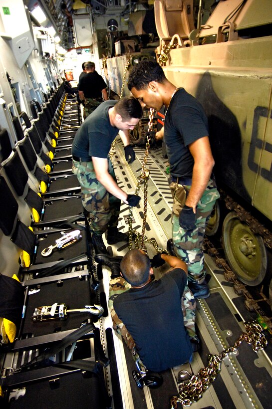 Airmen from the Combat Mobility Element, or CME, secure an armored personnel carrier on a C-17 Globemaster III at Royal Australian Air Force Base Townsville, Australia, on Tuesday, May 30, 2006  The CME is part of the 15th Logistical Readiness Squadron at Hickam Air Force Base, Hawaii. The CME is in Townsville to help prepare and load equipment on C-17s from Hickam that are repositioning Australian Defense Forces to better support peace operations in East Timor. (U.S. Air Force photo/Tech. Sgt. Shane A. Cuomo)