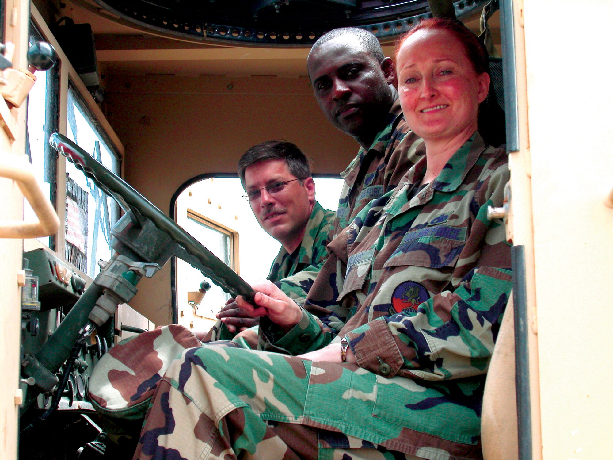 From left, Staff Sgt. John Traum and Tech. Sgts. Steven Smith and Cynthia Blais crowd into the cramped confines of a battle-scarred gun truck. Seeing the gun truck, similar to the ones they operated while conducting convoy duty in Southwest Asia in 2004, brought forth mixed emotions for the 908th Airlift Wing Logistics Readiness Squadron Transporation Flight Air Force Reservists. Photo by Staff Sgt. Jay Ponder, 908th Airlift Wing Public Affairs