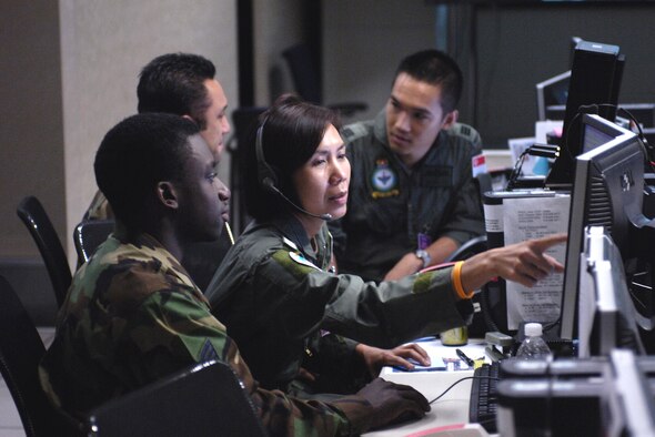 060524-F-2034C-002
Members from the U.S. Air Force, Thai Air Force and Singapore Air Force track a downed aircraft in Thailand May 24, 2006 during a scenario for Exercise Cobra Gold 06 at Kenney Headquarters Pacific Air Operations Center, Hickam Air Force Base Hawaii. The PAOC executes the planning and reach-back capabilities the headquarters can provide during war or during a contingency. (U.S. Air Force photo by Tech. Sgt. Shane A. Cuomo)
