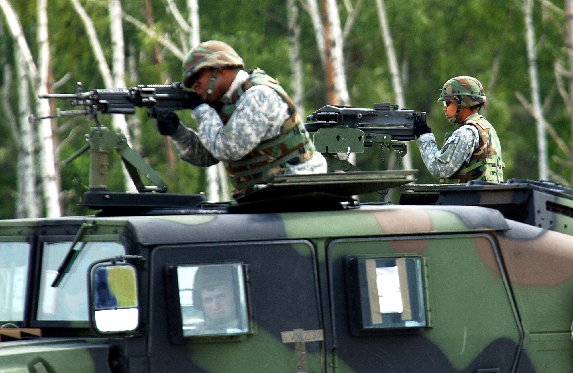 Soldiers from the 230th Military Police Company secure the area around a C-17 Globemaster III after a simulated assault landing during Operation Vigilant Star at Ramstein Air Base, Germany, on Wednesday, May 24, 2006. The purpose of this operation was to showcase the capabilities of the C-17 to NATO countries. (U.S. Air Force photo/Senior Airman Chris Willis)