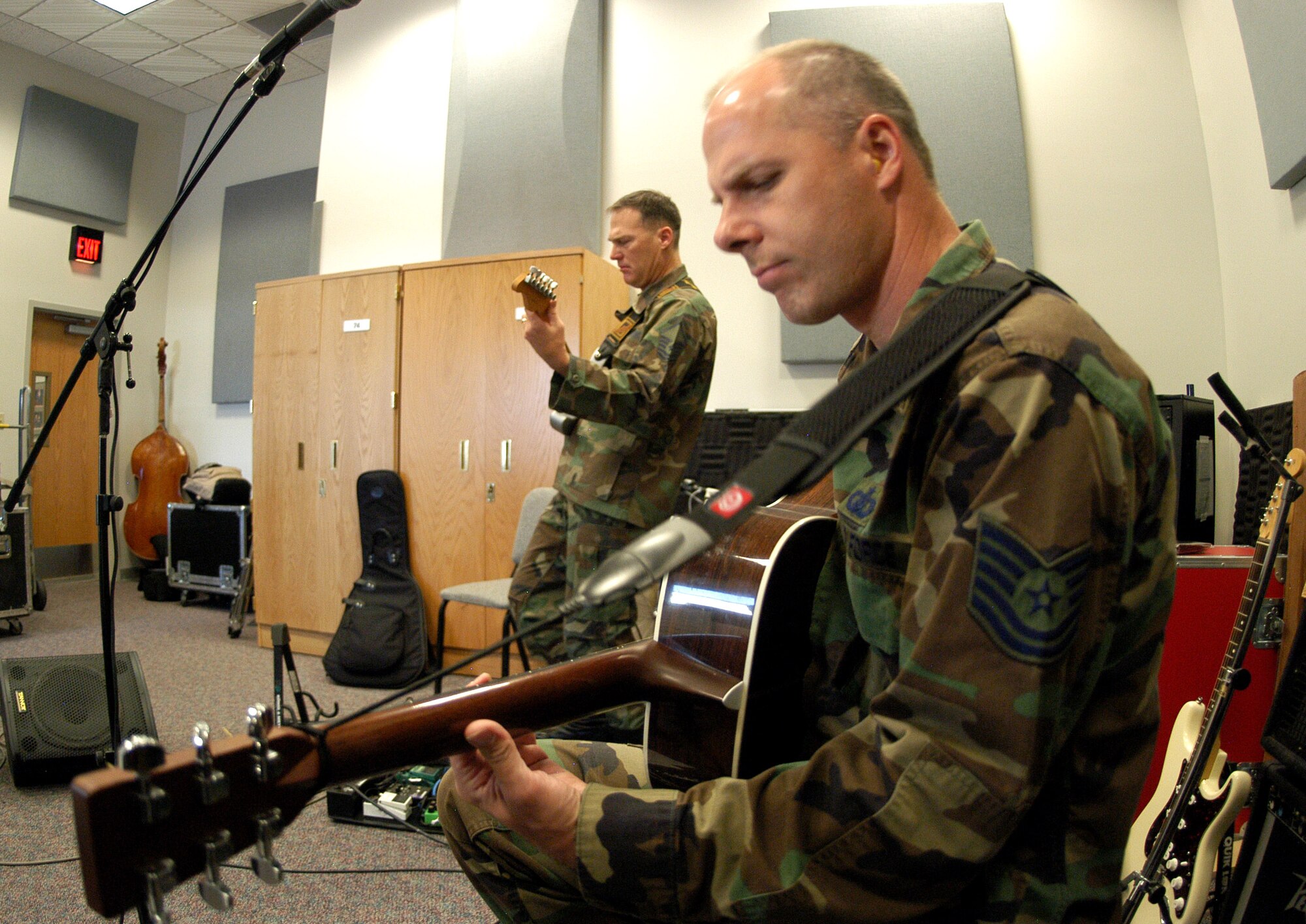 Guitarists Master Sgt. James Bristow and Tech. Sgt. Stephen Brannen of Wild Blue Country rehearse for the band's upcoming deployment to the Middle East. The group will bring music to several forward operating bases that have not had live entertainment. (U.S. Air Force photo/1st Lt. John Ross) 

