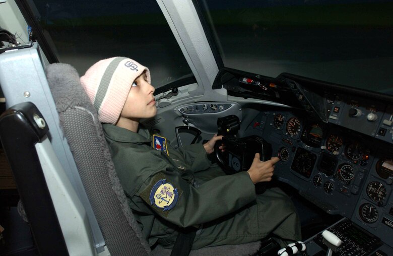 Ten-year-old Katie Powell flies a KC-10 Extender simulator at Travis Air Force Base, Calif., as part of the Pilot for a Day program on Friday, May 19, 2006. The program provides wish-fulfillment opportunities to local children with life-threatening diseases. Katie is fighting Ewing’s Sarcoma, a rare bone cancer. She is the daughter of Senior Master Sgt. Chris Powell, 60th Operations Group. (U.S. Air Force photo/Andre Mansour)
