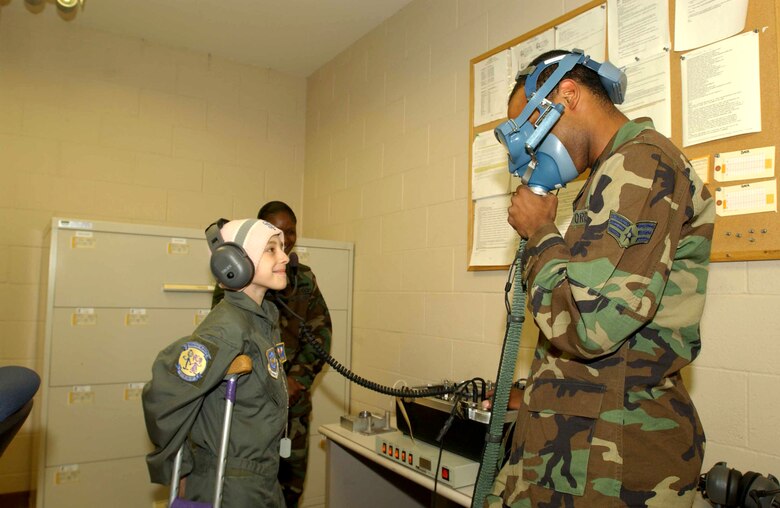 Ten-year-old Katie Powell visits the life support branch at Travis Air Force Base, Calif., as part of the Pilot for a Day program on Friday, May 19, 2006. The program provides wish-fulfillment opportunities to local children with life-threatening diseases. Katie is fighting Ewing's Sarcoma, a rare bone cancer. She is the daughter of Senior Master Sgt. Chris Powell, 60th Operations Group. (U.S. Air Force photo/Andre Mansour)