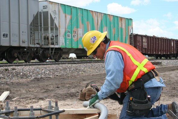 F.E. WARREN AIR FORCE BASE, Wyo.-- John Lucero, a contractor with WG Dale Electric, works to get a conduit in place to support camera towers that are being installed as part of security upgrades along the railroad line that runs through the base. Col. Michael Carey, 90th Space Wing commander, recently traveled to Washington to meet with congressional delegations from Wyoming, Colorado and Nebraska to inform them of wing and Air Force issues as part of the Commander Capitol Hill Visitation Program. Upgrading base security was one of many issues the commander discussed during his Capitol Hill visit. “I’m proud of what we do here, and I will continue to advocate for us and carry the Air Force message to Capitol Hill,” Colonel Carey said.  (Courtesy photo)