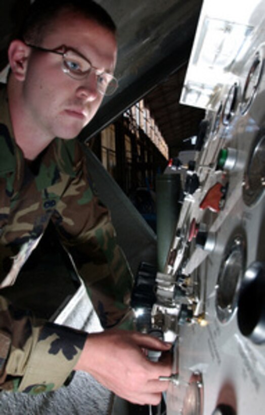 Air Force Senior Airman Kenneth Lemanski adjusts the engine throttle and checks for loose wires on a self-generating nitrogen cart prior to starting it at Aviano Air Base, Italy, on May 25, 2006. The nitrogen cart produces 95-percent-pure nitrogen and is used to service wheels and struts on aircraft. Lemanski is attached to the 31st Maintenance Squadron. 
