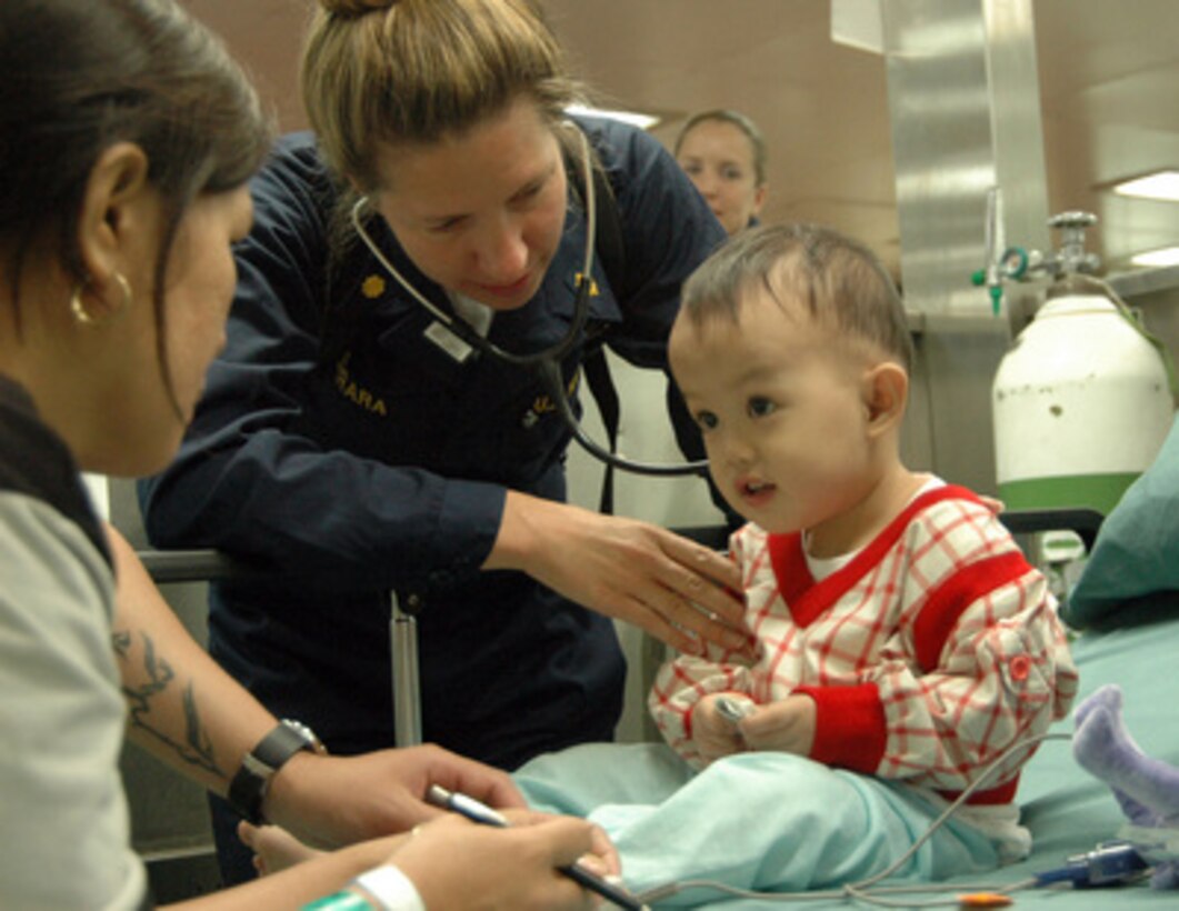 U.S. Navy Lt. Cmdr. Elizabeth Ferrara checks a boy's vital signs onboard the hospital ship USNS Mercy (T-AH 19) anchored off the coast of Zamboanga, Philippines, on May 27, 2006. The ship is conducting a humanitarian and civic assistance mission in the area during its five-month deployment to South Asia, Southeast Asia and the Pacific Islands. Ferrara is a Navy pediatrician. 