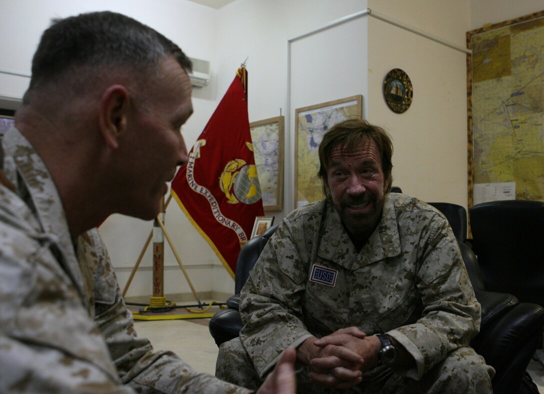 Martial arts expert and action film star, Chuck Norris talked to Maj. General Richard Zilmer, commanding general Multi-National Force-West, when he visited Camp Fallujah November 1. Norris and fellow actor Marshall Teague toured camps throughout Al Anbar province and Kuwait as a part of their United Service Organization sponsored trip. The action stars hoped to raise the morale of the troops, give inspirational speeches, and provide a handshake with a smile. They made Camp Fallujah their ninth stop of 11, finishing up their tour with stops in Camps Ramadi and Taqaddum to visit the troops there. â??I came here to see the morale of the troops and to give them a morale boost,â? said Norris. â??If it helps them in any way positively, Iâ??m elated.â? Photo by Cpl. Lynn Murillo