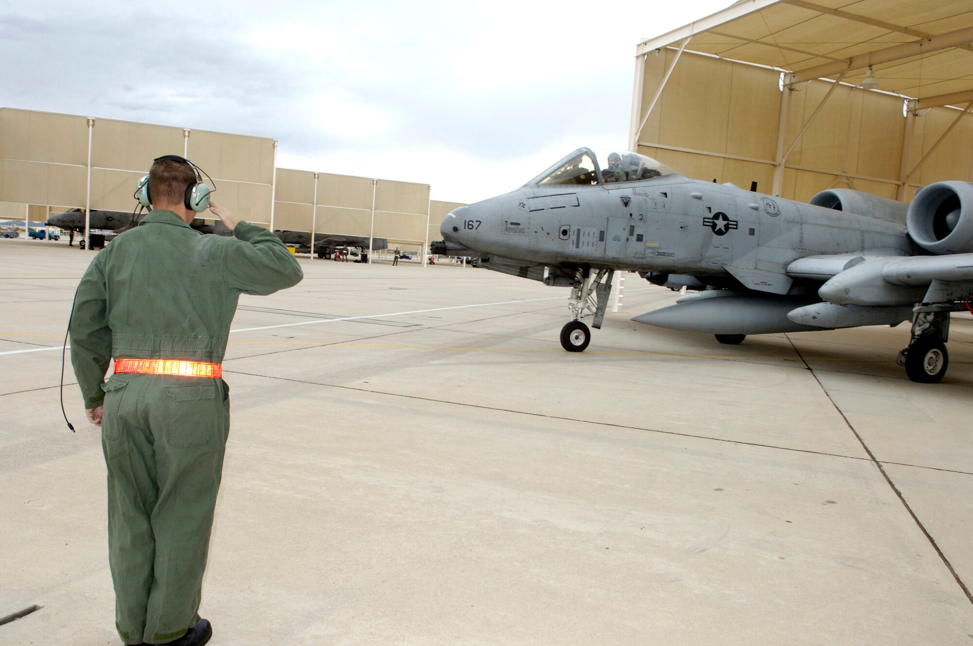 Tech. Sgt. Jerome Westbrook salutes as Capt. Andrew Tenenbaum taxis his A-10 Thunderbolt II Oct. 29.  Sergeant Westbrook is assigned to the 355th Aircraft Maintenance Squadron and Captain Tenenbaum is a pilot in the 354th Fighter Squadron at Davis-Monthan Air Force Base, Ariz.  (U.S. Air Force photo/Senior Airman Jesse Shipps)