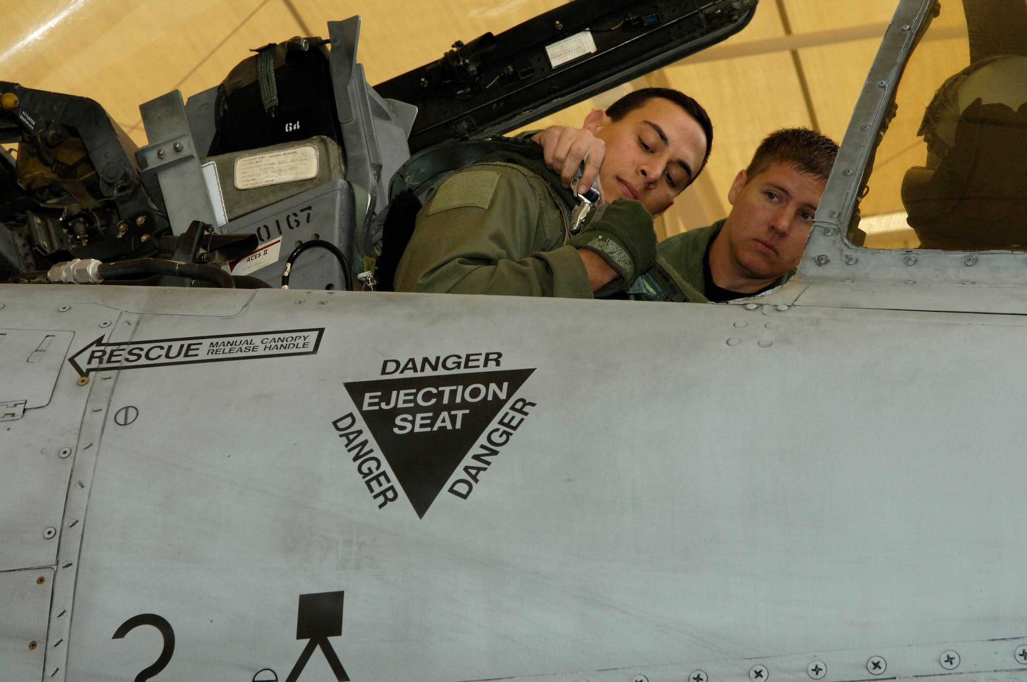 Tech. Sgt. Jerome Westbrook helps Capt. Andrew Tenenbaum strap into his A-10 Thunderbolt II Oct. 29 prior to a mission.  Sergeant Westbrook is assigned to the 355th Aircraft Maintenance Squadron and Captain Tenenbaum is a pilot in the 354th Fighter Squadron at Davis-Monthan Air Force Base, Ariz.  (U.S. Air Force photo/Senior Airman Jesse Shipps)