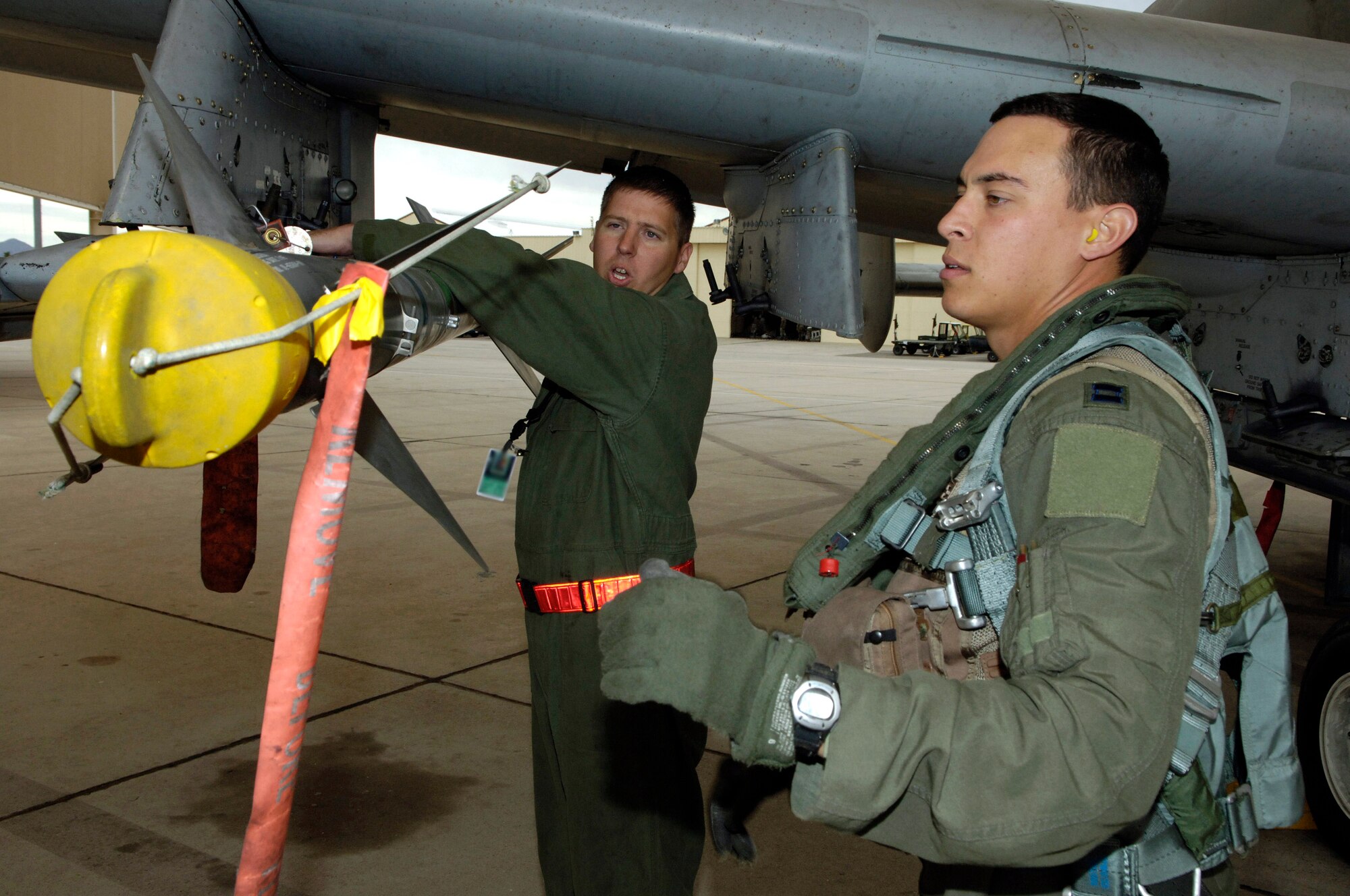 Tech. Sgt. Jerome Westbrook checks an AIM-9 missile with Capt. Andrew Tenenbaum during the captain's pre-flight inspection of his A-10 Thunderbolt II Oct. 29 prior to a mission.  Sergeant Westbrook is assigned to the 355th Aircraft Maintenance Squadron and Captain Tenenbaum is a pilot in the 354th Fighter Squadron at Davis-Monthan Air Force Base, Ariz.  (U.S. Air Force photo/Senior Airman Jesse Shipps)