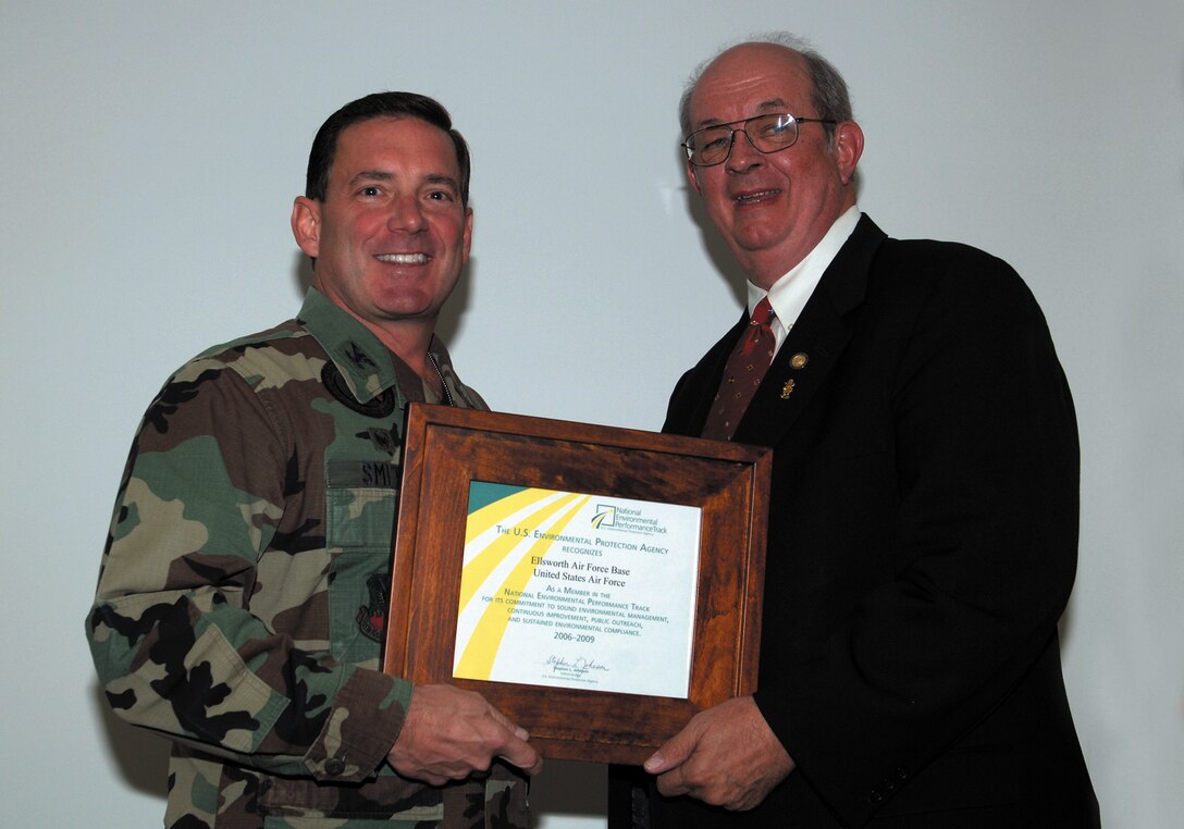 Robert E. Roberts, the regional administrator with the Environmental Protection Agency awards 28th Bomb Wing Commander Jeffry Smith membership into the National Environmental Performance Track Program. Ellsworth is the first Air Force-owned installation to earn membership into this prestigious program, given to companies that demonstrate sustained compliance with environmental policies. (U.S. Air Force Photo by A1C Angela Ruiz)  


