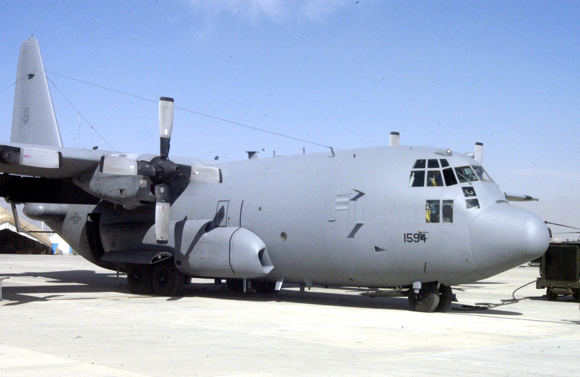 An EC-130H Compass Call sits on the flightline at Bagram Air Base, Afghanistan, while maintainers perform a routine check. The 41st Expeditionary Electronic Combat Squadron aircrew members have flown more than 5,000 combat hours in support of the war on terrorism. The aircraft and members from the squadron are deployed from Davis-Monthan Air Force Base, Ariz. (U.S. Air Force photo/Capt. Vince King Jr.)                   