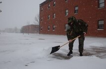 Senior Airman Andrew Close, 5th Communications Squadron, shovels snow in front of the 5th CS dorms during a snowfall on October 30. The base recived about three inches of snow. (U.S. Air Force photo by Airman Sharida Bishop)