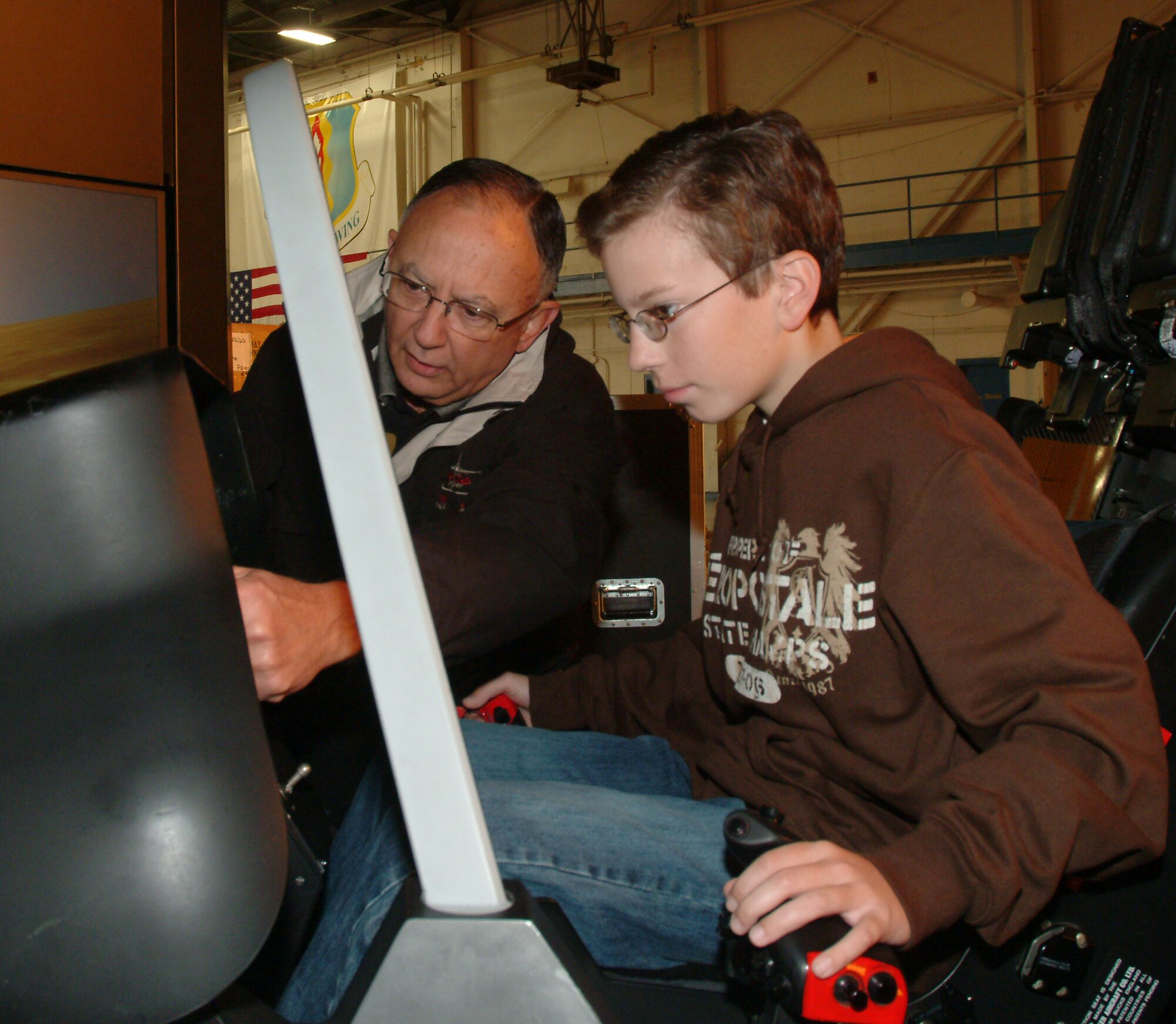 Evan Thompson, son of Kathy Thompson, 53d Wing Staff, got a first-hand look at the Joint Strike Fighter after flying in the Lockheed-Martin’s simulator Wednesday at the 33d Maintenance Operation Squadron training hangar.
“It was awesome—it was more high tech than I though it would be,” said the 14-year-old freshman, who’s enrolled in aeronautical courses at Choctaw High School and aspires to design jets or related software. “It was amazing the control panels didn’t have as many switches or dials as compared to the F-15. There was only one screen in front of you where you could access everything you needed.”  (U.S. Air Force photo by Staff Sgt. Samuel King Jr.)
